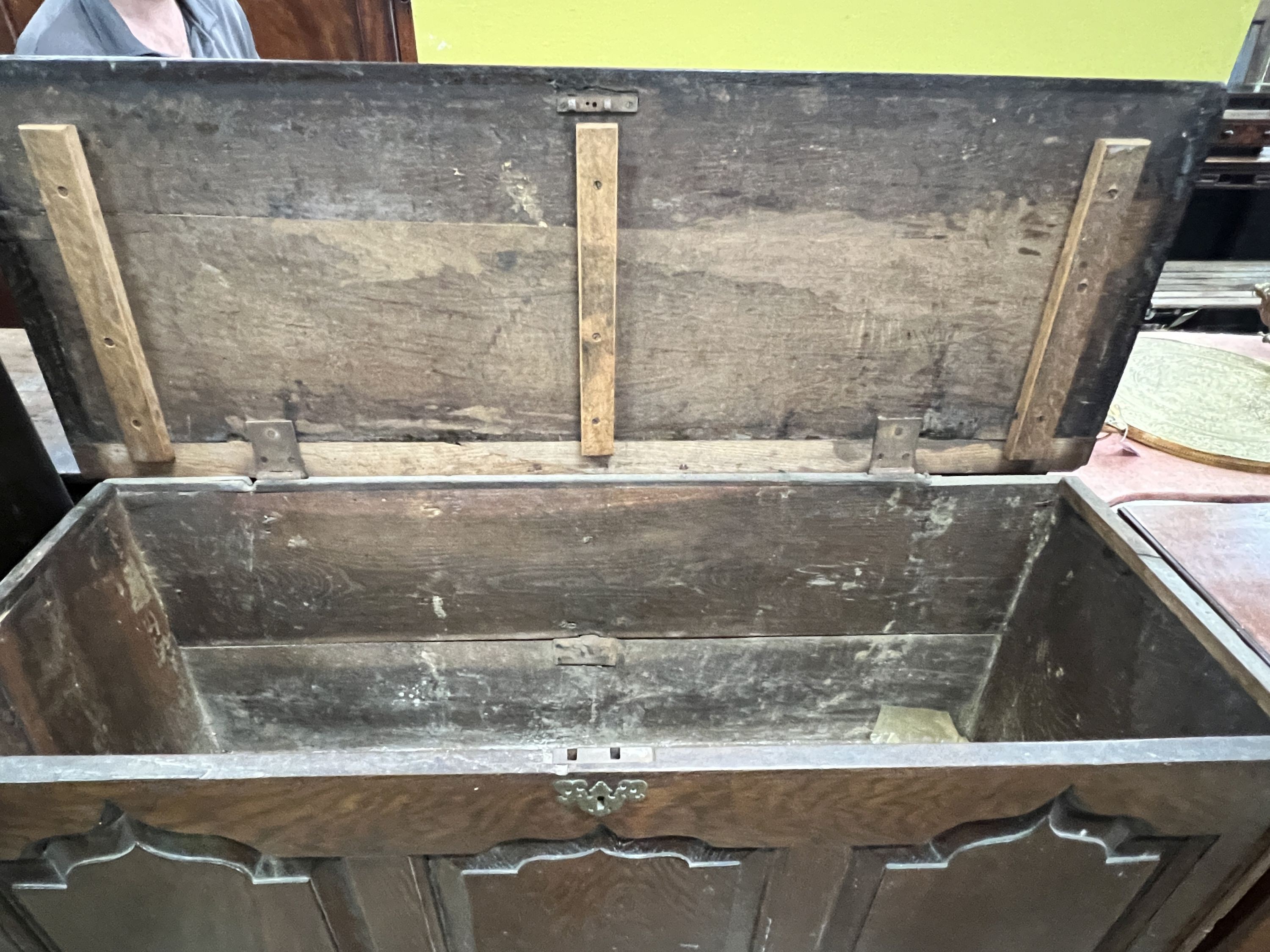 A mid 18th century oak mule chest with arched triple panelled front, width 144cm, depth 51cm, height 97cm